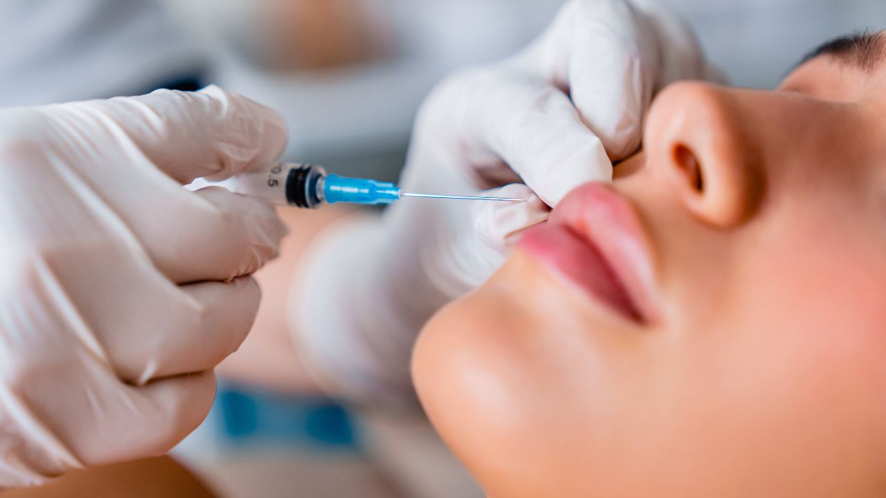 a woman getting lip injections for uneven lips